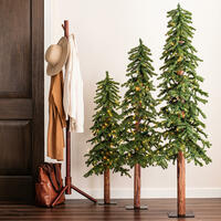 Alpine artificial Christmas tree with exposed wood trunk and sparse natural styling
